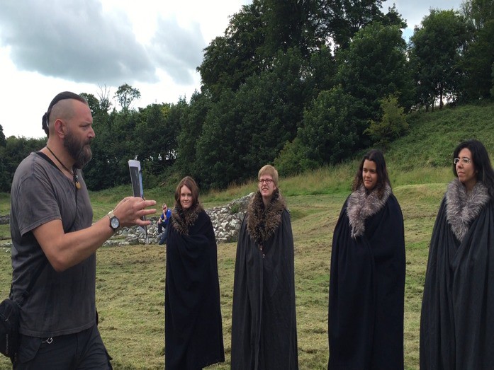 Tour group doing a scene renaactment at Inch Abbey